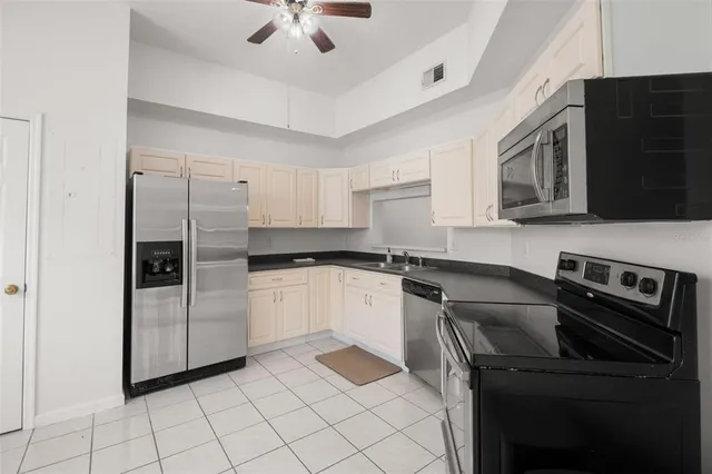 a kitchen with a refrigerator stove and microwave