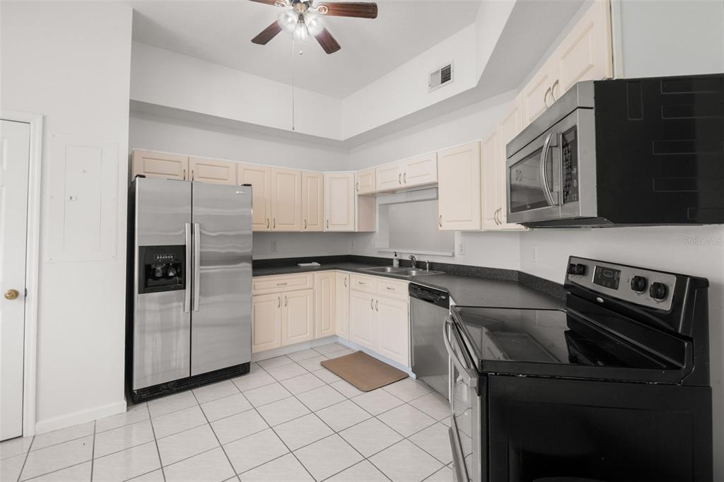 1644 Arabian Lane Palm Harbor, FL 34685 - Photo 7 of 52 a kitchen with a refrigerator stove and microwave