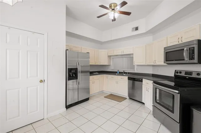 a kitchen with a refrigerator and a sink
