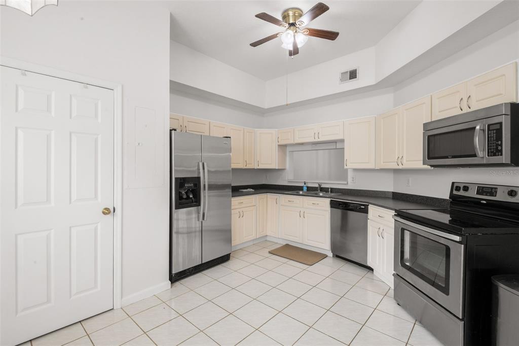 1644 Arabian Lane Palm Harbor, FL 34685 - Photo 9 of 52 a kitchen with a refrigerator and a sink