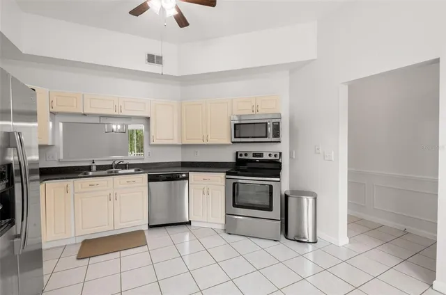 a kitchen with granite countertop cabinets stainless steel appliances and a counter space