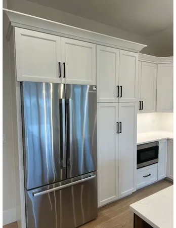 a kitchen with stainless steel appliances a refrigerator and cabinets