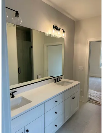 a bathroom with a double vanity sink and mirror