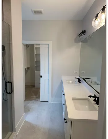 a bathroom with a sink and shower