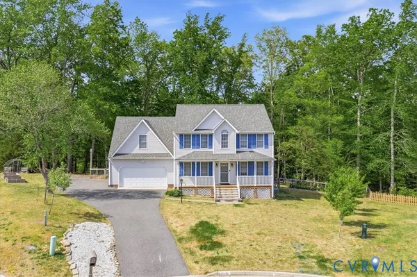 a aerial view of a house with a yard table and chairs