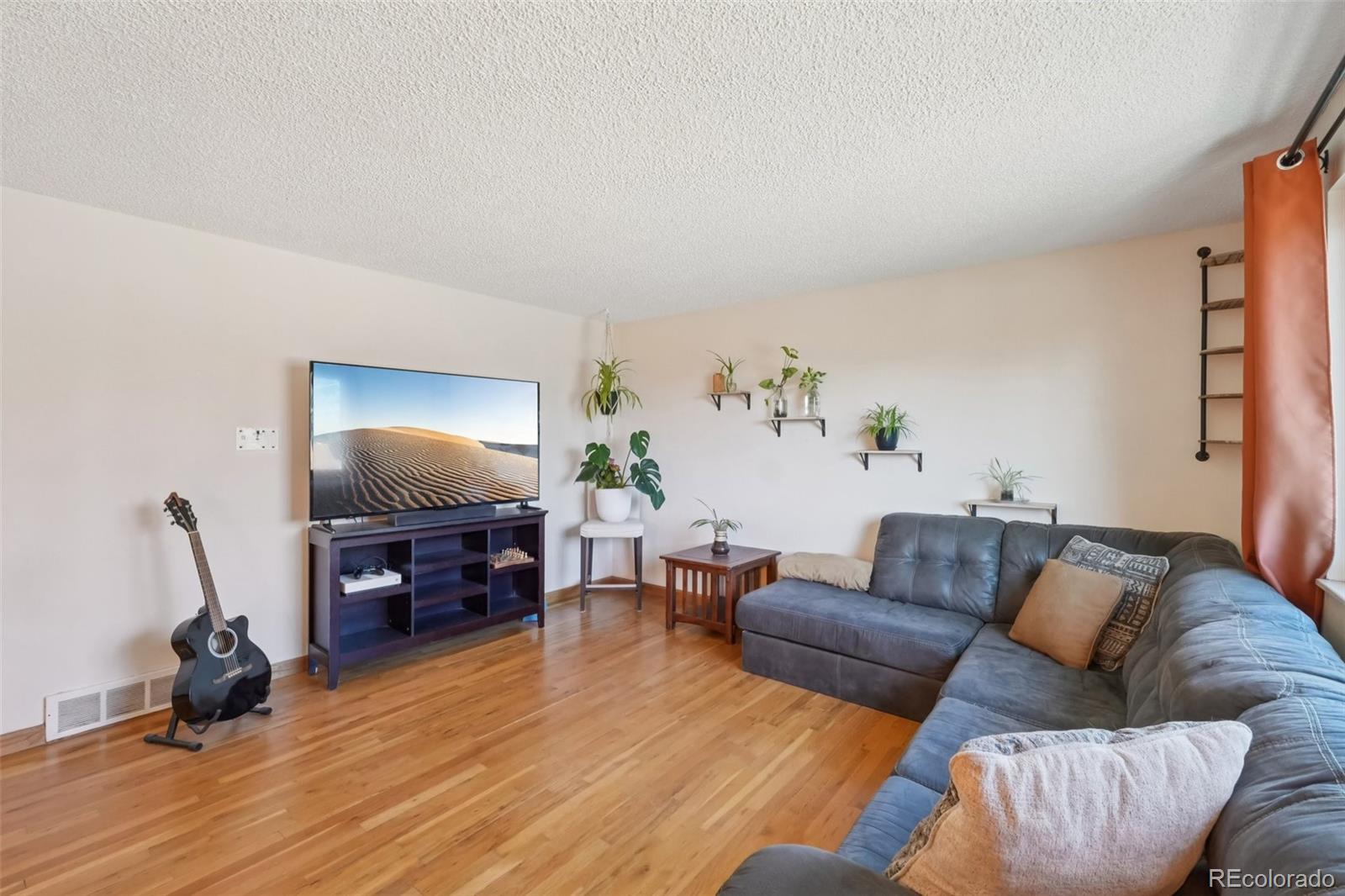 6277 Reed Court Arvada, CO 80003 - Photo 11 of 40 a living room with furniture and a flat screen tv