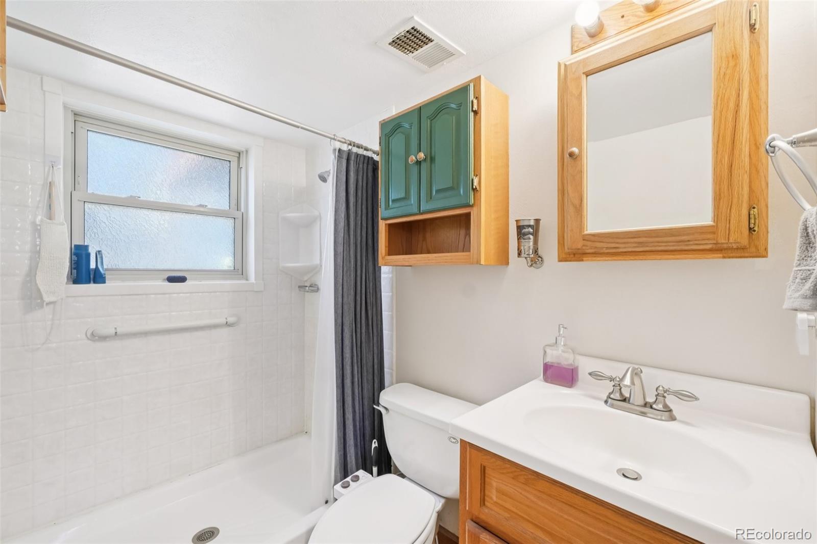 6277 Reed Court Arvada, CO 80003 - Photo 16 of 40 a bathroom with a sink a toilet and shower