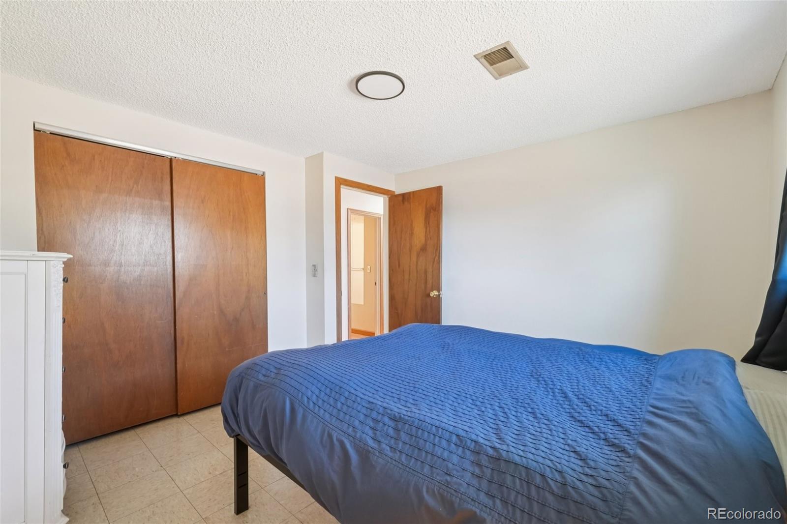 6277 Reed Court Arvada, CO 80003 - Photo 33 of 40 a bedroom with a bed and wooden floor