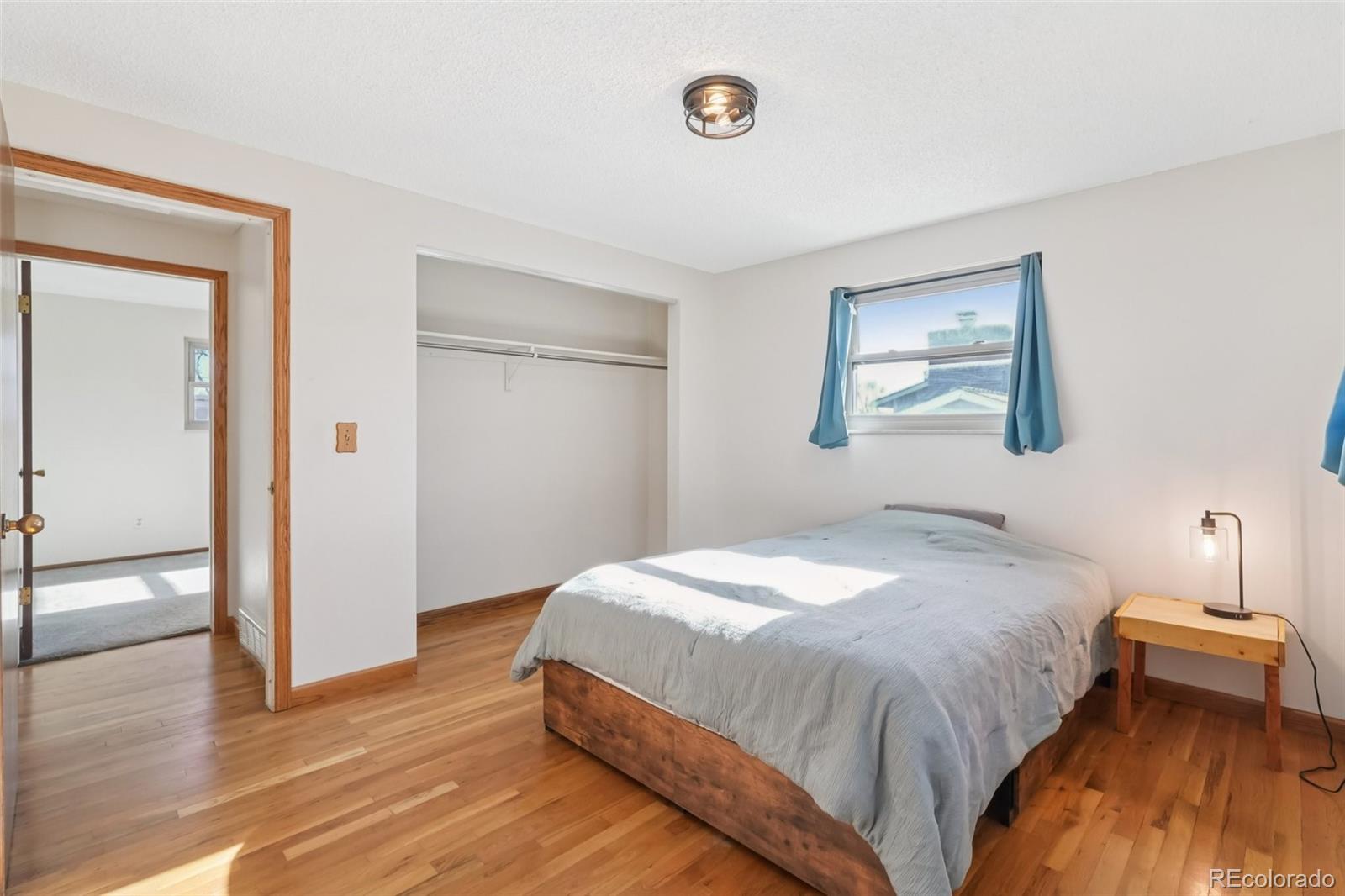 6277 Reed Court Arvada, CO 80003 - Photo 36 of 40 a bedroom with a bed and a lamp