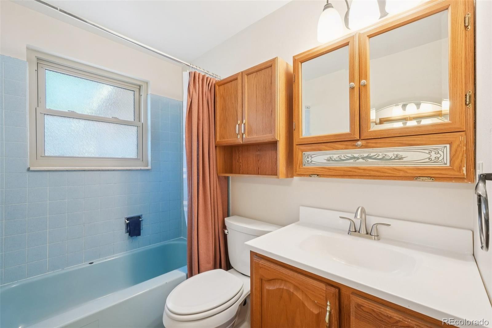 6277 Reed Court Arvada, CO 80003 - Photo 39 of 40 a bathroom with a sink a toilet and tub