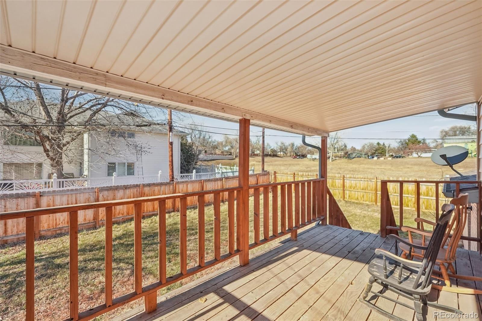 6277 Reed Court Arvada, CO 80003 - Photo 4 of 40 a view of a chairs and table in the balcony