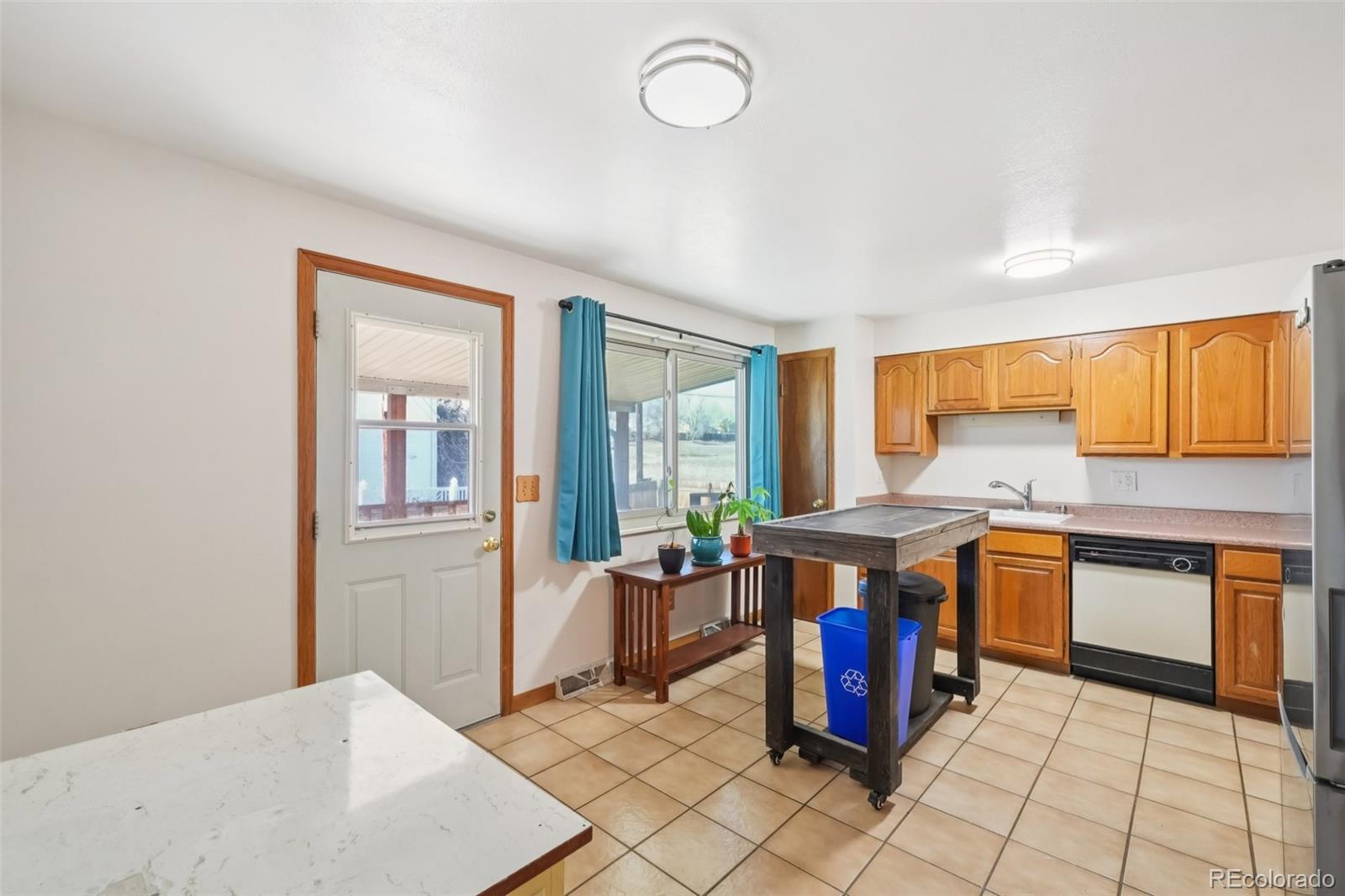 6277 Reed Court Arvada, CO 80003 - Photo 7 of 40 a kitchen with stainless steel appliances granite countertop a stove a sink dishwasher and a refrigerator