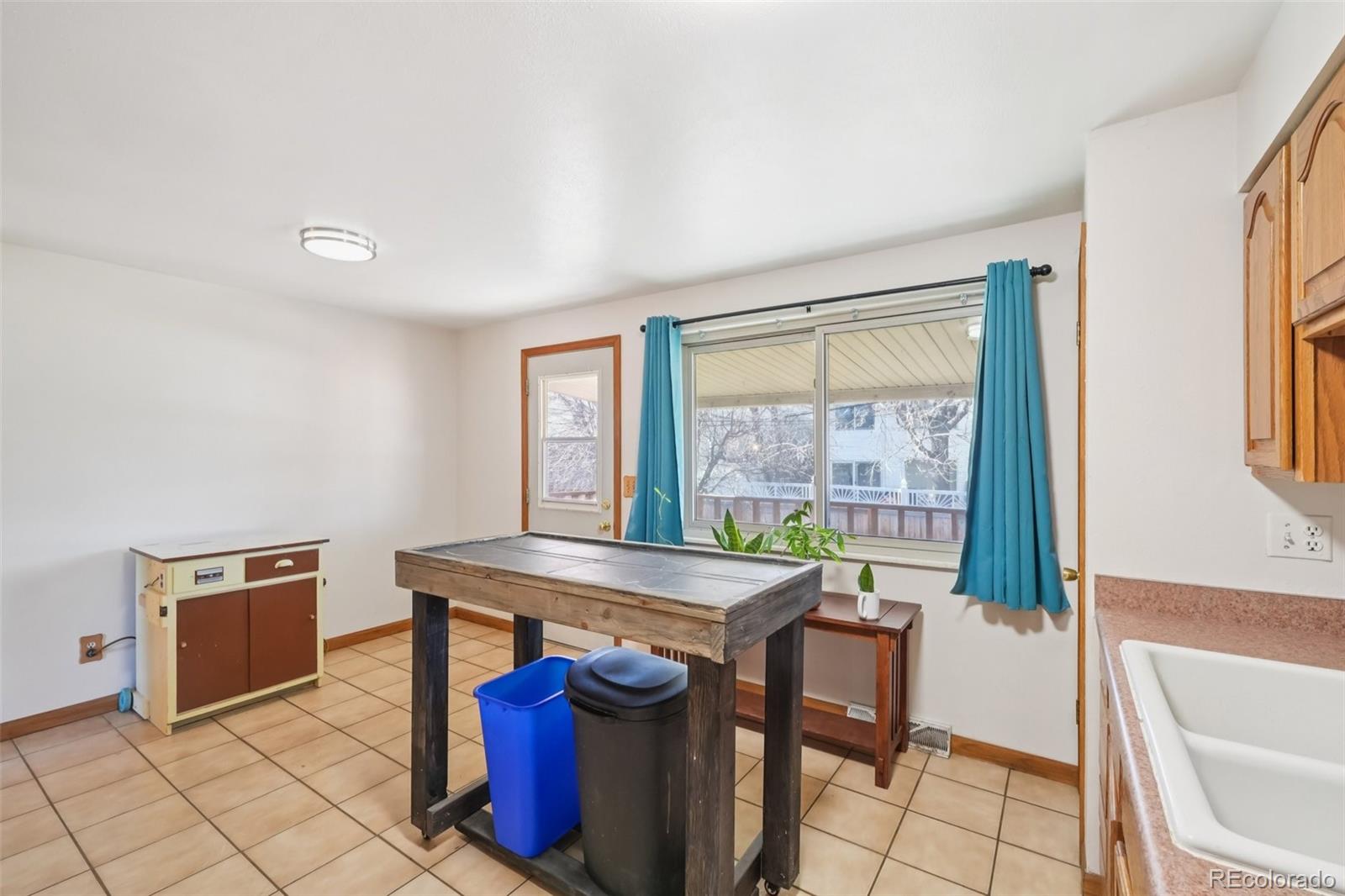 6277 Reed Court Arvada, CO 80003 - Photo 9 of 40 a view of a dining room with furniture window and outside view