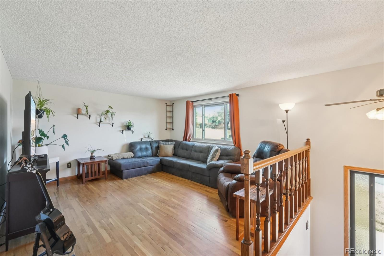 6277 Reed Court Arvada, CO 80003 - Photo 10 of 40 a living room with furniture and wooden floor