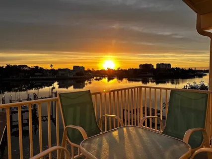 a view of a chairs and table in the balcony