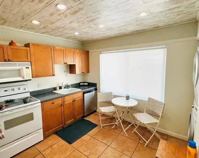 a kitchen with a table chairs and a stove