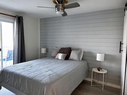 a bedroom with a bed and chair