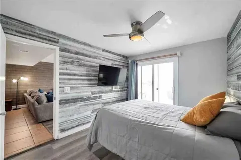 a bedroom with a bed and a flat screen tv