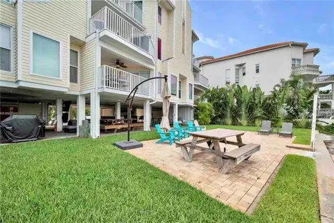 a view of a building with a yard patio and sitting area