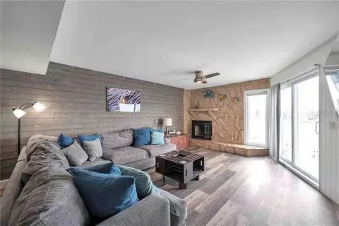 a living room with furniture large window and a fireplace
