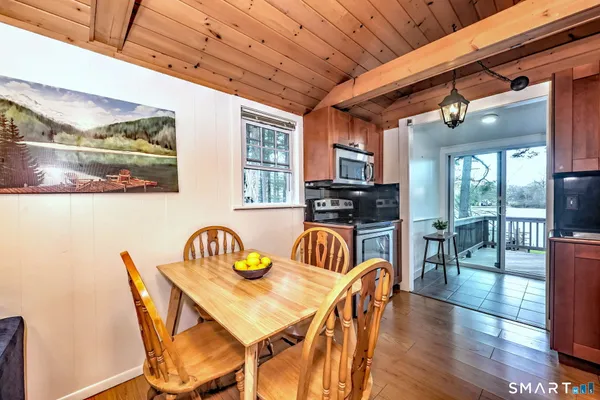 a dining room with furniture a rug and wooden floor