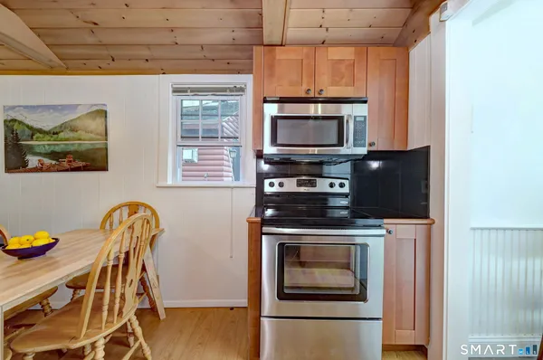 a kitchen with stainless steel appliances a stove a sink and a microwave