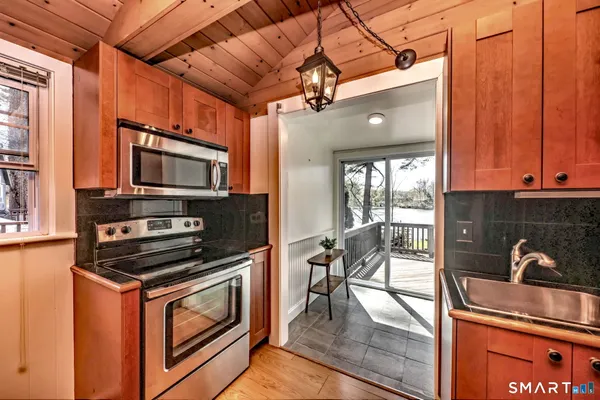 a kitchen with a sink a counter top space and stainless steel appliances