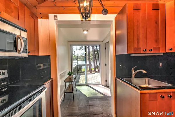 a view of an entryway with wooden floor and garden