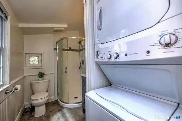 a bathroom with a toilet a sink and glass door