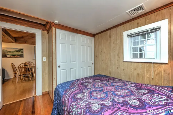 a bedroom with a bed and a table