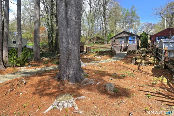 a view of a house with backyard and sitting area
