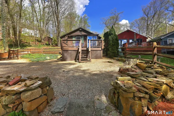 a roof deck with wooden floor and fence