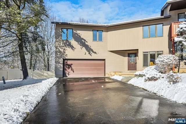 a view of a house with a snow in the yard