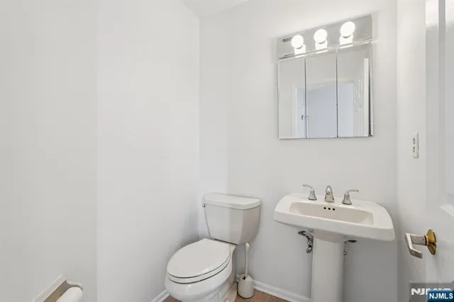 a bathroom with a sink a toilet and mirror