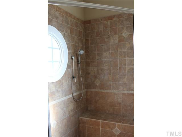 2108 Tulare Court Raleigh, NC 27612 - Photo 17 of 25 Shower with seat shampoo wand style brushed nickel fixture. Porthole window. Master Bath/Spa