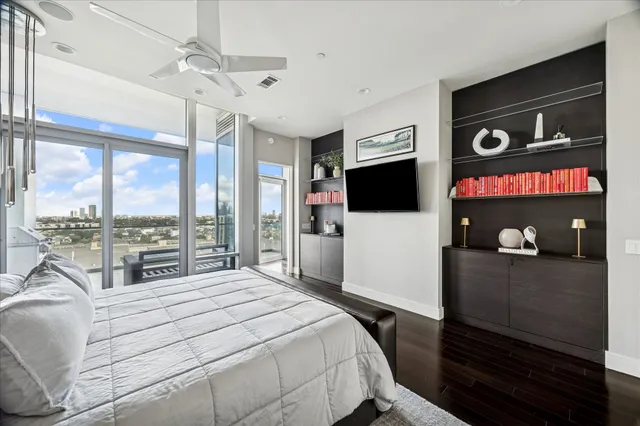 a bedroom with a bed and a flat tv screen on the dresser