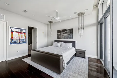 a bedroom with a bed and a painting on the wall