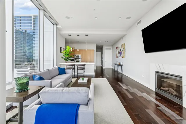 a living room with furniture a flat screen tv and a fireplace