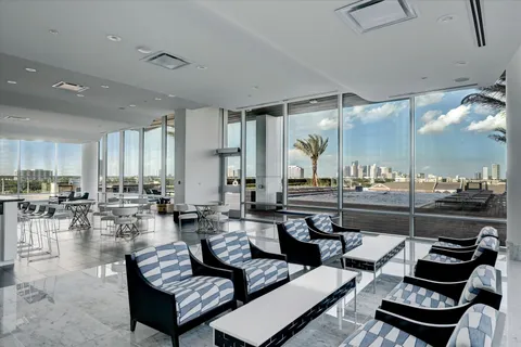 a living room with lots of furniture and view of kitchen