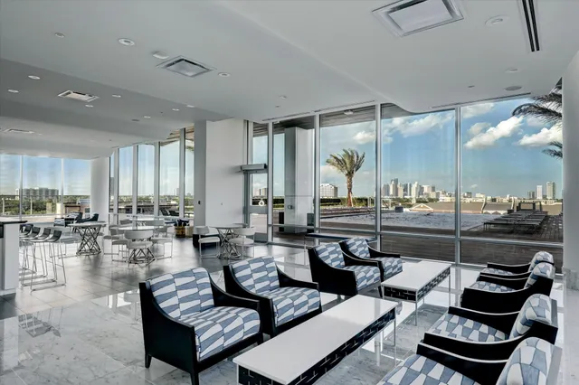 a living room with lots of furniture and view of kitchen