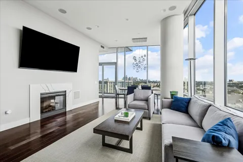a living room with furniture a fireplace and a flat screen tv