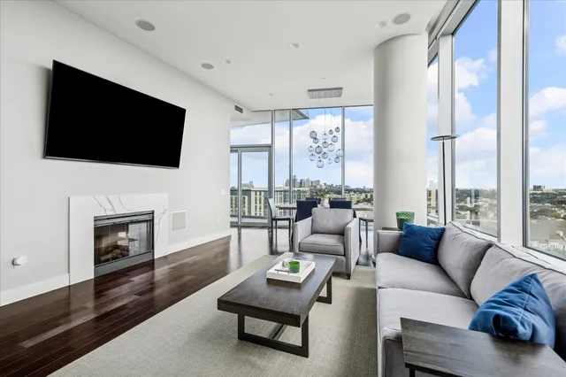 a living room with furniture a fireplace and a flat screen tv