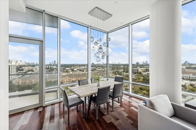 a dining room with furniture window and wooden floor