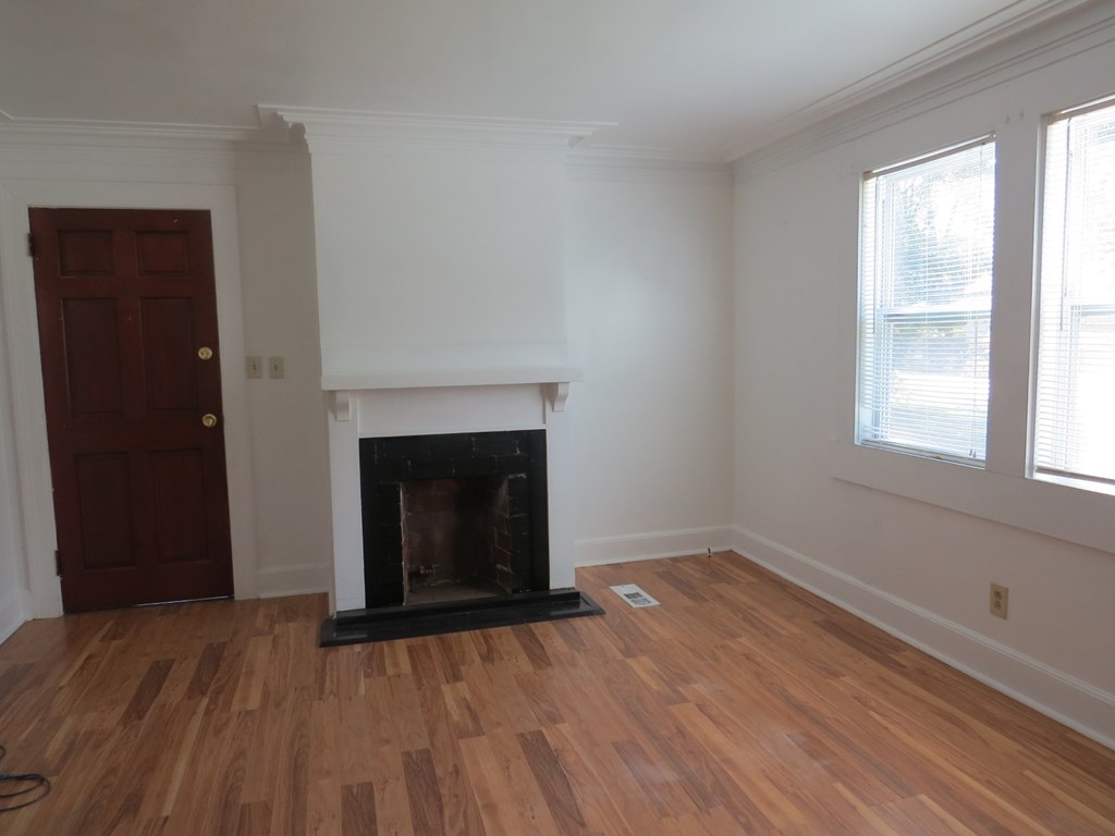 4247 Forrest Road Columbus, GA 31907 - Photo 2 of 17 wooden floor fireplace and windows in an empty room