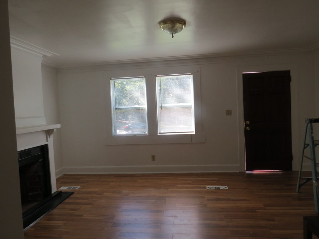 4247 Forrest Road Columbus, GA 31907 - Photo 3 of 17 a view of empty room with wooden floor and fireplace