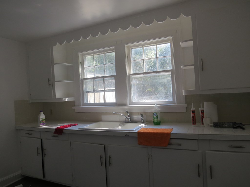 4247 Forrest Road Columbus, GA 31907 - Photo 5 of 17 a kitchen with a sink cabinets and window
