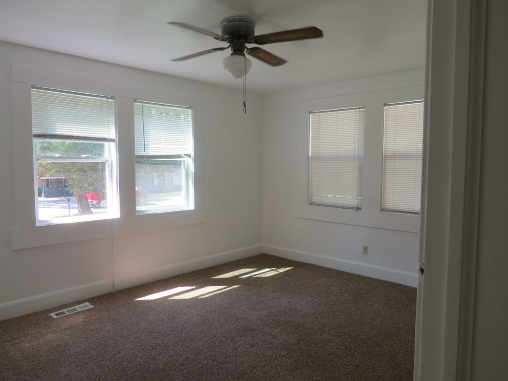 4247 Forrest Road Columbus, GA 31907 - Photo 7 of 17 an empty room with windows and fan