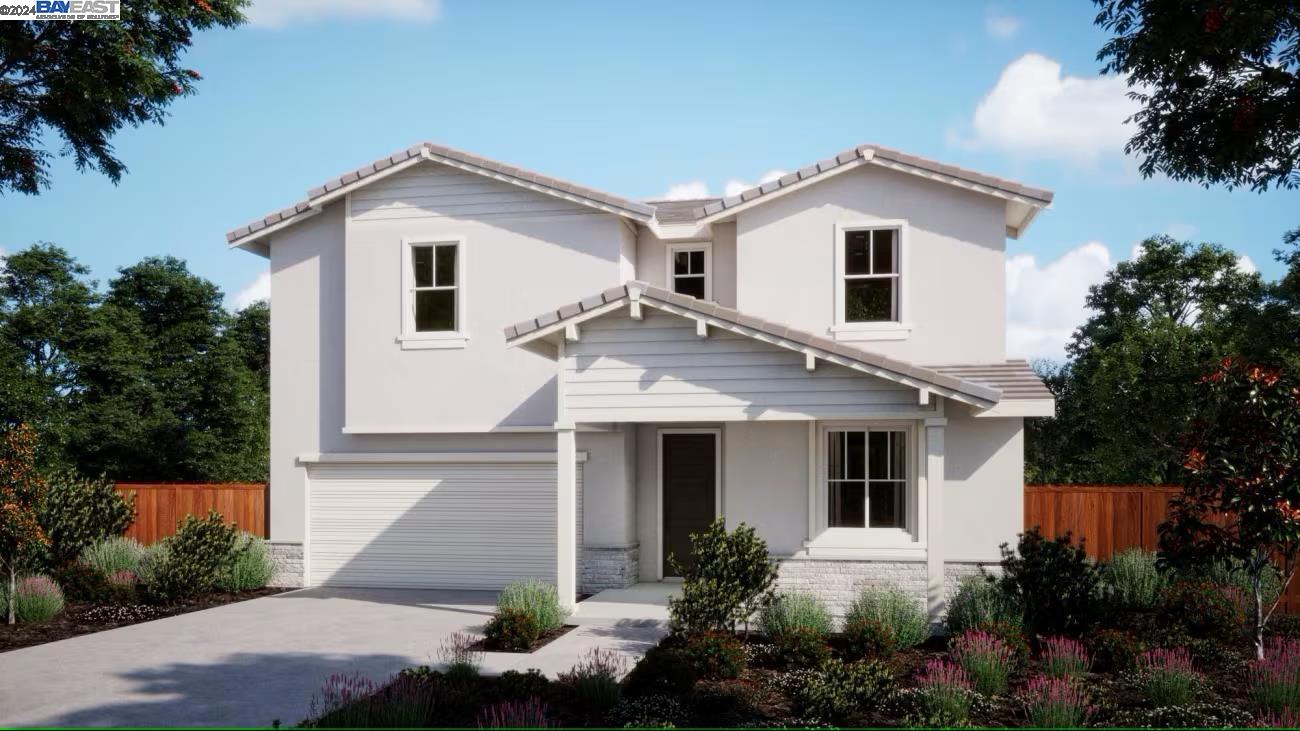 2209 Stagecoach Road Patterson, CA 95363 - Photo 1 of 1 a view of a white house next to a yard with potted plants
