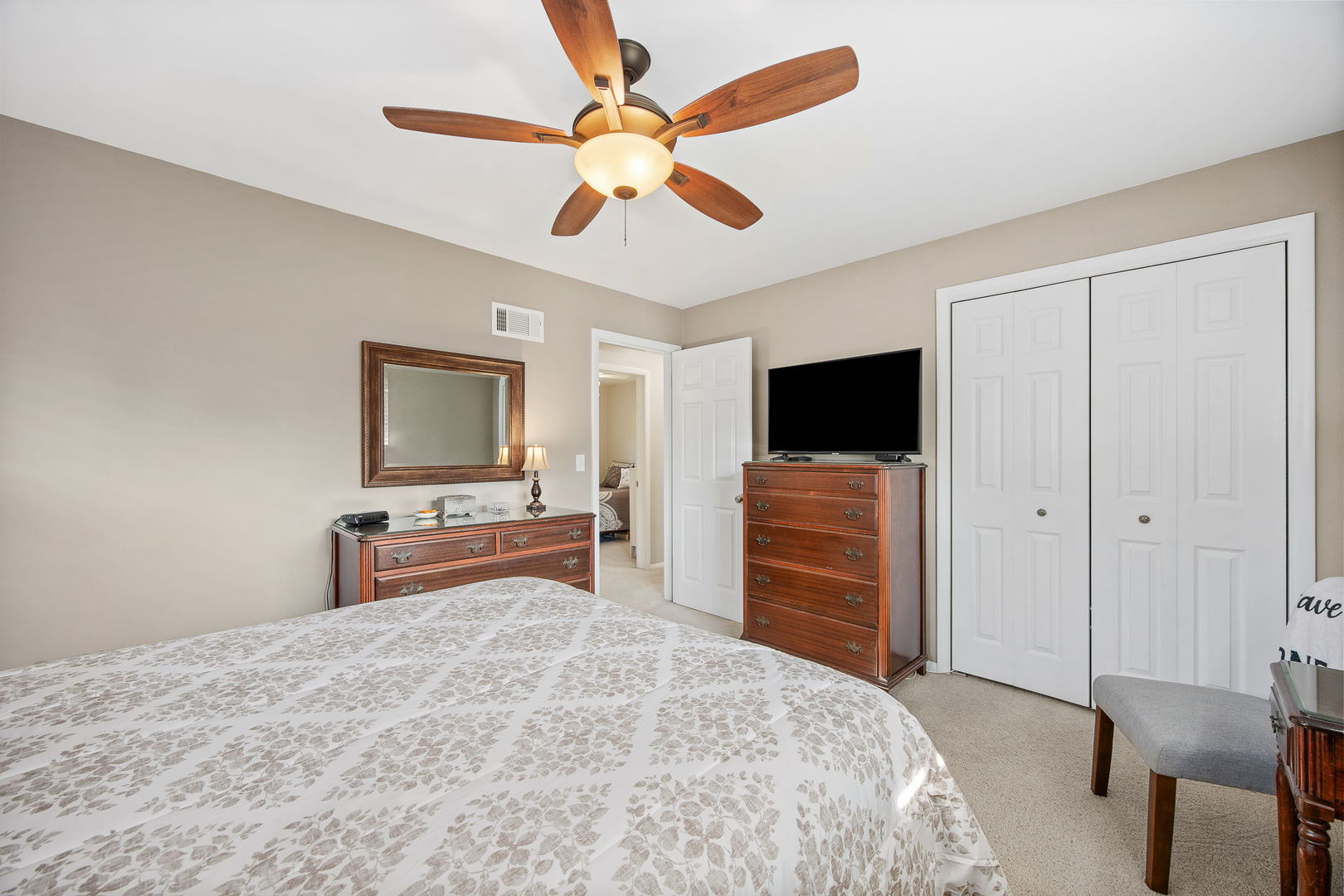 723 Inverness Road Lisle, IL 60532 - Photo 14 of 40 a bedroom with a bed and a flat screen tv