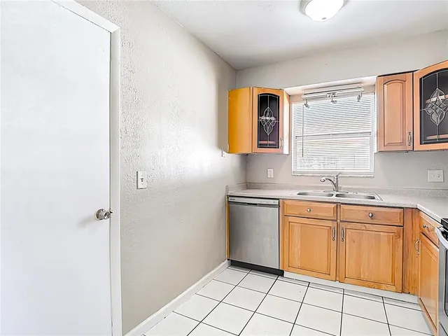a kitchen with a sink cabinets and window